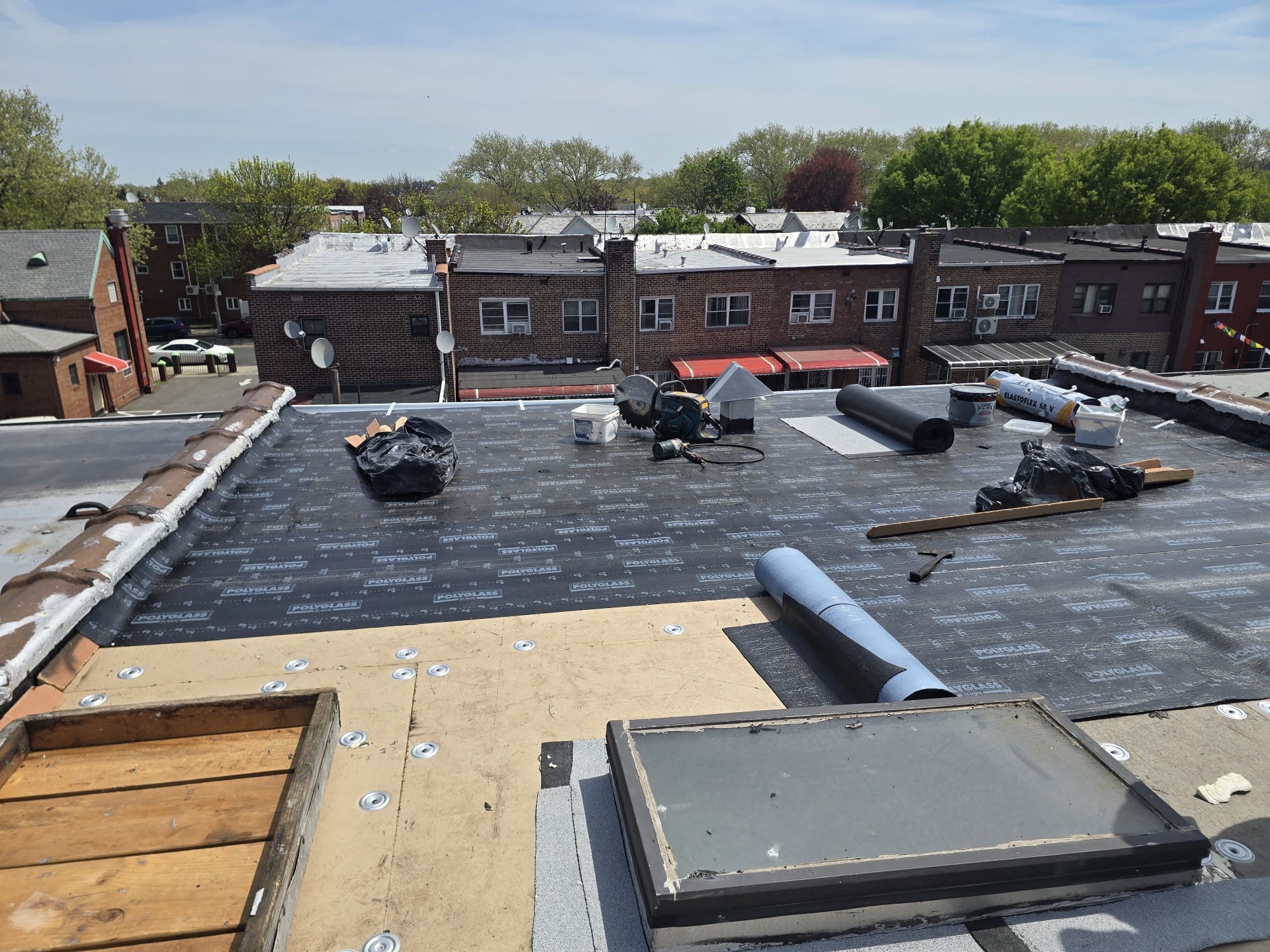 Roofing crew working on a flat commercial roof