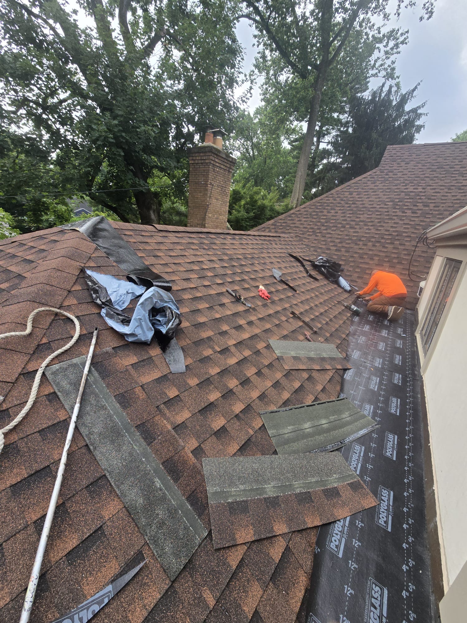 Crew installing a new roofing system